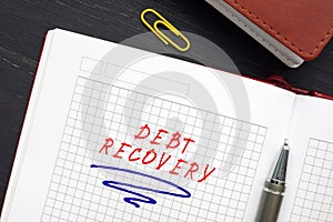 Business concept about DEBT RECOVERY with inscription on the sheet. Debt recoveryÂ is when aÂ a credit card balance continues to